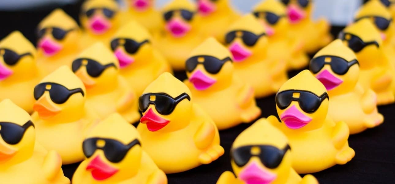 Rows of yellow rubber ducks wearing sunglasses